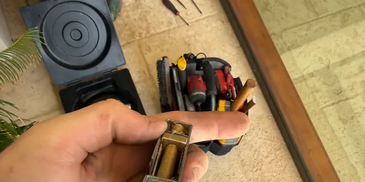 Technician holding patio door handle hardware