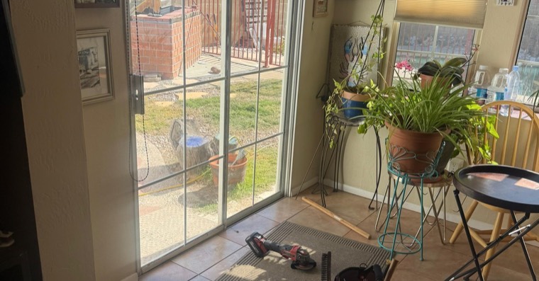 Indoor sliding door work area with lower track visible