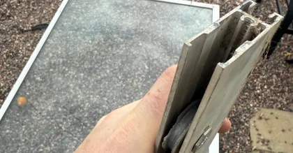 Close-up of sliding door roller and lower track