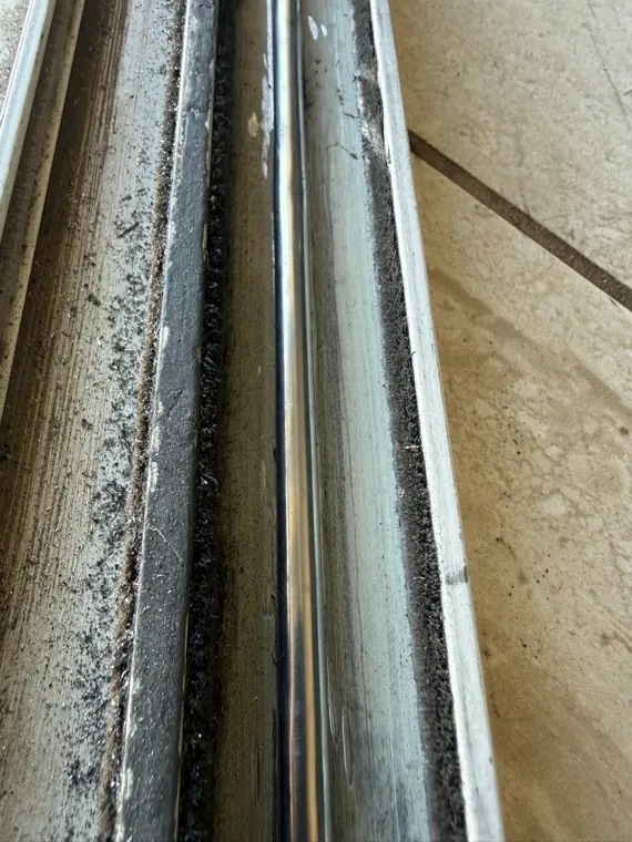 Lower sliding door track area that can affect how the panel closes